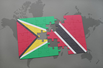 puzzle with the national flag of guyana and trinidad and tobago on a world map background.