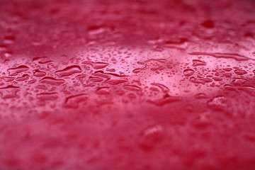 Rain drops on red background