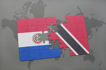 puzzle with the national flag of paraguay and trinidad and tobago on a world map background.