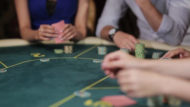 A group of people in an underground casino bet