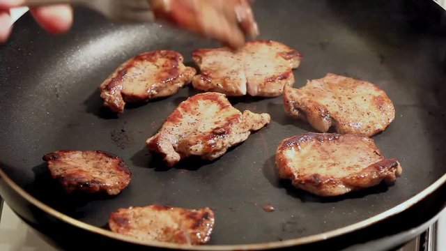 fry the meat in a frying pan, Chef preparing and spicing meat restaurant kitchen