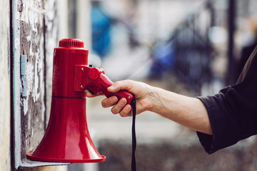 Human hand pick up the megaphone