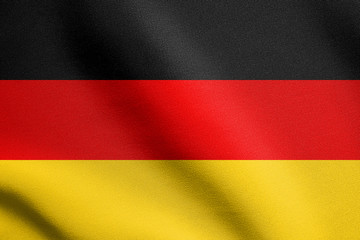 Flag of Germany waving in wind with fabric texture