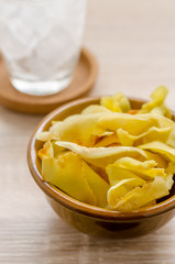 Durian chips fried snack fruit in brown blow on wooden backgroun