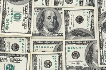piles of one hundred dollars banknotes