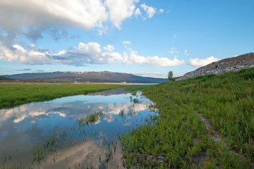 Snake River under cumulus clouds in Alpine Wyoming USA