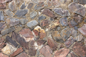 real medieval stone wall surface can use as background pattern or texture at old town Songkhla Thailand
