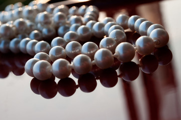 Pearl beads on a glossy surface