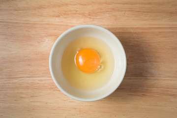 bowl of raw yolk on a wooden block