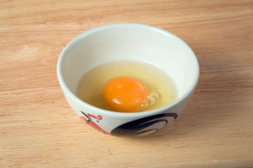 bowl of raw yolk on a wooden block