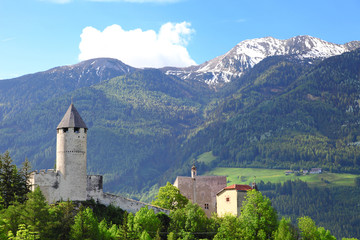 Fototapeta na wymiar historic castle and mountain landscape at Dolomites alps, Italy