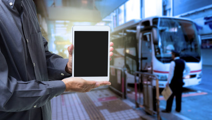 Hand holding tablet computer with blur bus terminal  background,Digital Marketing concept
