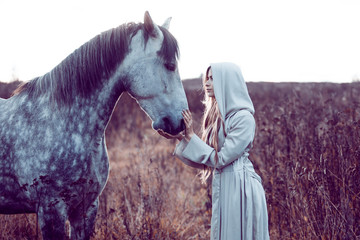 girl in the hooded cloak with horse, effect of toning