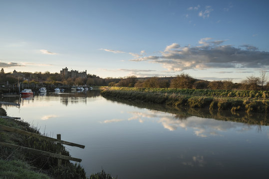 Landscape image of old medieval Castle viewed across River at su