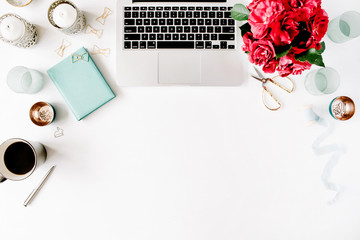 Flat lay, top view office table desk. Workspace with laptop, red roses bouquet, mint diary, coffee mug and golden scissors on white background.