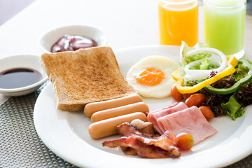 Breakfast set, bread, orange juice , guava juice, fried egg,ham,