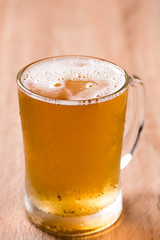 beer in mug glass on wood table