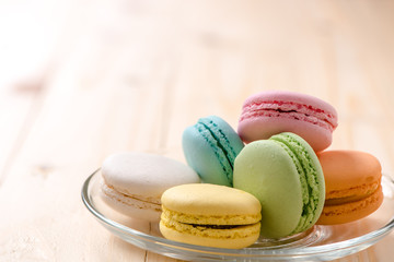 Macaron in plate on wood table