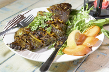 Oven Baked Tilapia fish with vegetables and Spinach.