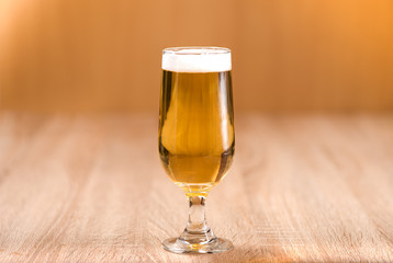 beer in glass on wood table