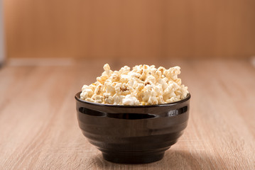 closeup popcorn in bowl on wood table