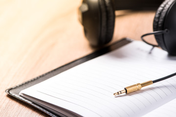 book and headphone on wood table ,music idea