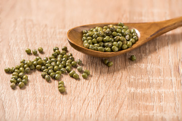greens bean in spoon on wood table
