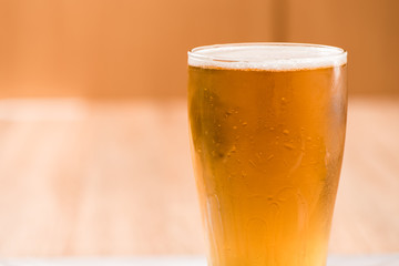 Beer in glass,on wood background