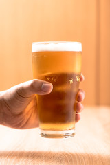 Beer in glass,on wood background