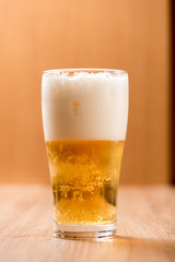 Beer in glass,on wood background