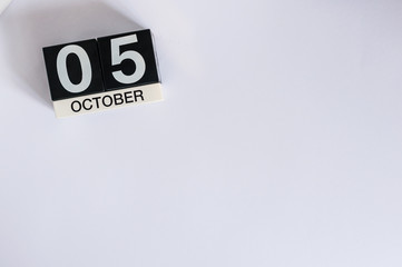 October 5th. Day 5 of month, wooden color calendar on white background. Autumn time. Empty space for text
