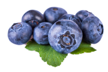 Fresh blueberries with leaves isolated on white background
