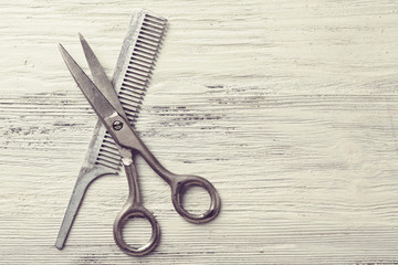 Vintage tools of barber shop on light wooden background