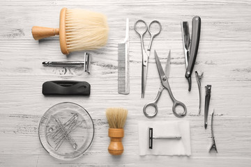 Vintage tools of barber shop on light wooden background