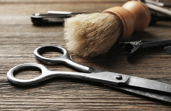 Vintage tools of barber shop on wooden background