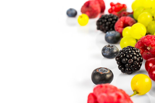 Various fresh summer fruits and berries isolated on a white background. Close-up.