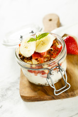 Homemade dessert with granola, banana and strawberry