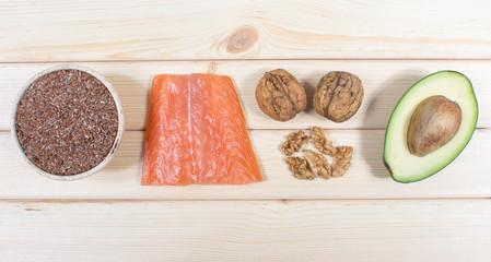 Sources of omega 3 fatty acids: flaxseeds, avocado, salmon and walnuts - obrazy, fototapety, plakaty