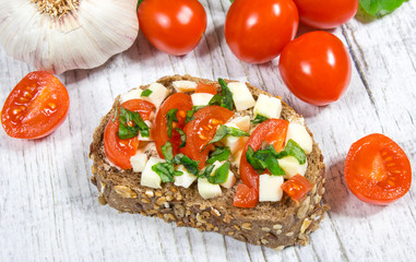 Ciabatta bread with tomatoes, mozzarella and basil.