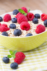 Oatmeal porridge with berries. Raspberries and blueberries.