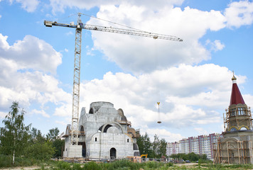 Obraz premium High industrial crane at construction site of church