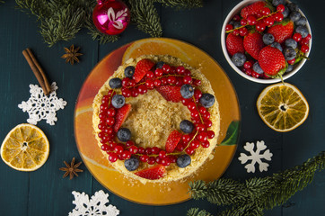 Napoleon cake with berries and fruit on wooden background. to celebrate Christmas or New Year decorated with fir branches, cones. Top view.