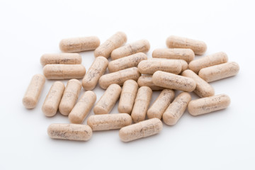 Ginkgo biloba capsule on the white background.