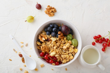 healthy granola in white bowl and summer berries