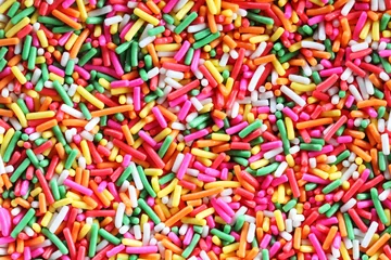 Fototapeten colorful sugar sprinkle background. © sakhorn38