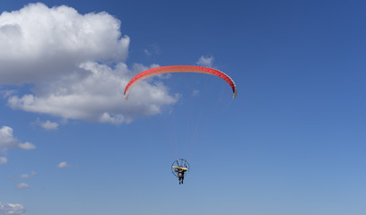 Paragliding in the blue sky