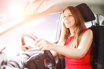 Young lady driving car. Driving school background