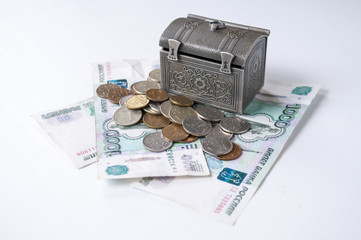 Decorative chest stands on the banknotes and small coins