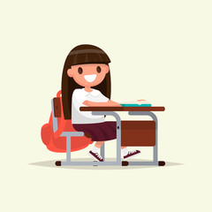 Student elementary school. The schoolgirl sits at a school desk.