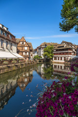 Fototapeta premium Strasbourg, France. The picturesque landscape with reflection in the water of old buildings in the old quarter 